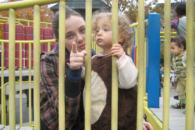 One of the ticketed women in a playground accompanied by a minor.
